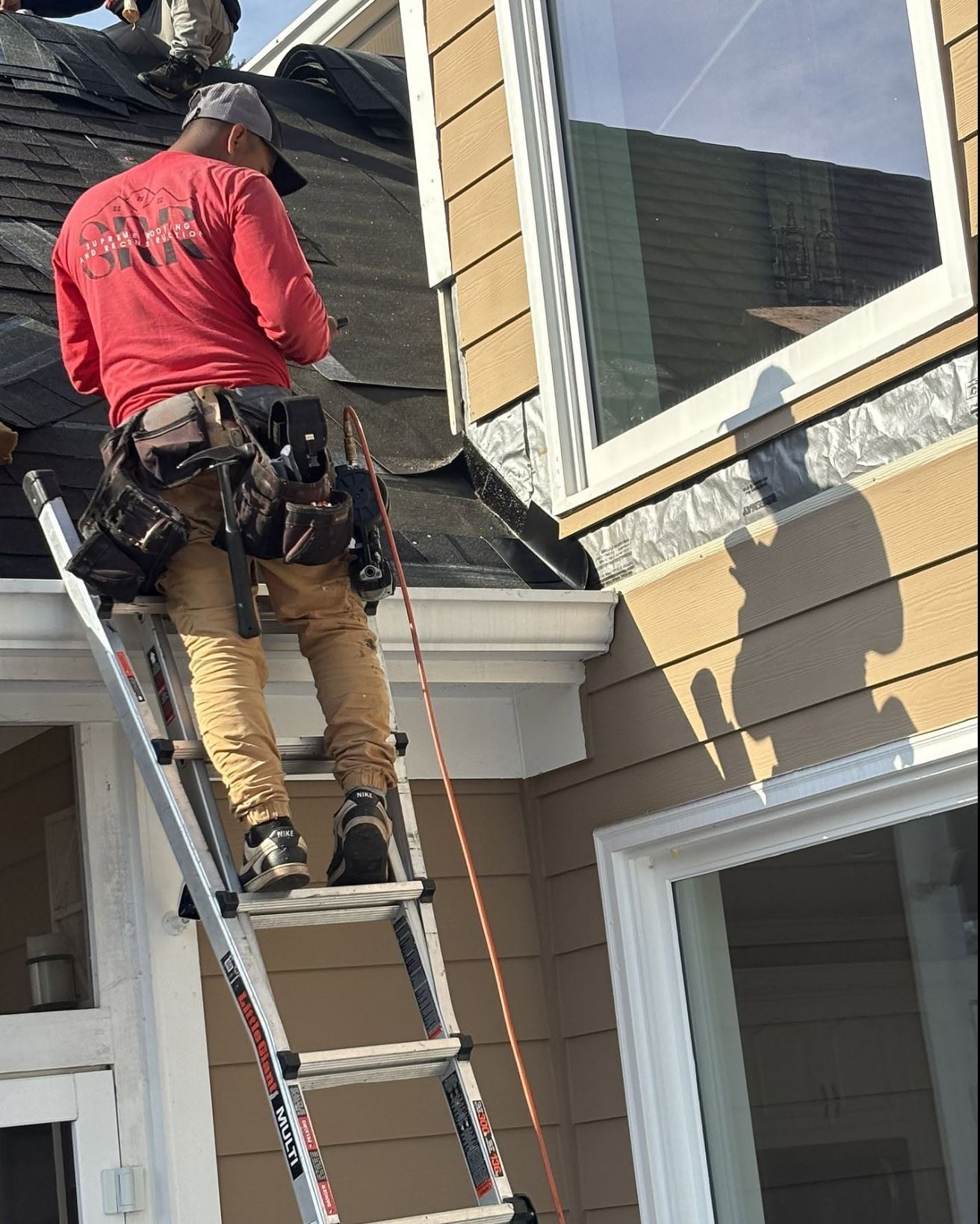 Supreme Roofing crew installing gutters in Roswell, Fulton County GA